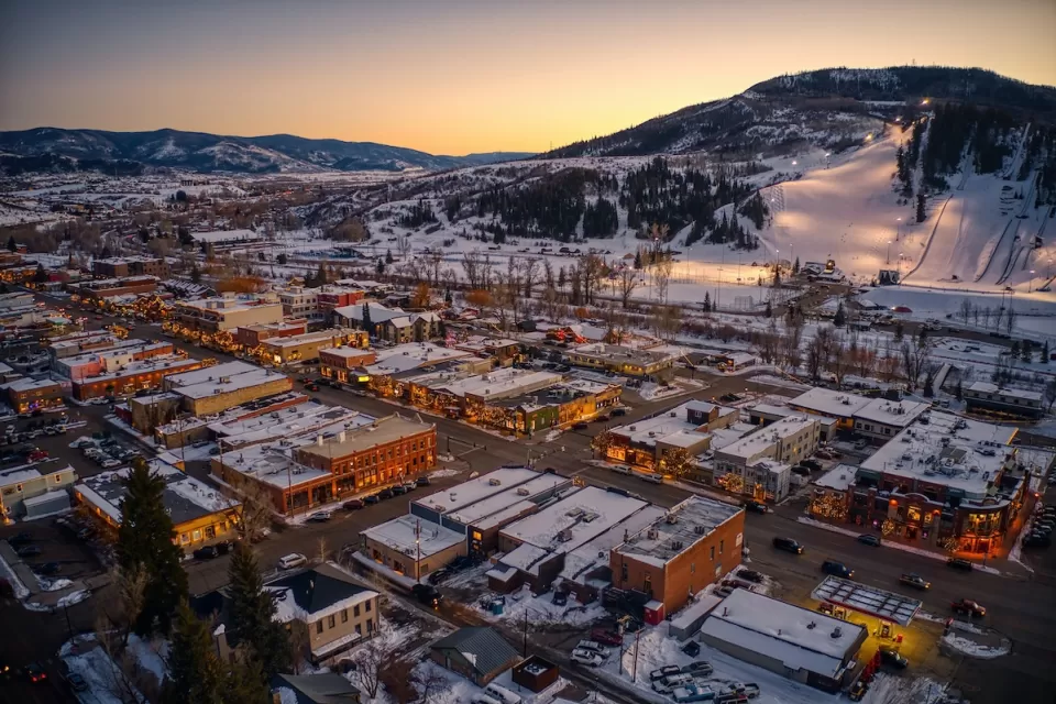 Aerial view of mountain town of Steamboat Springs, Colorado in the winter with snow at dusk.